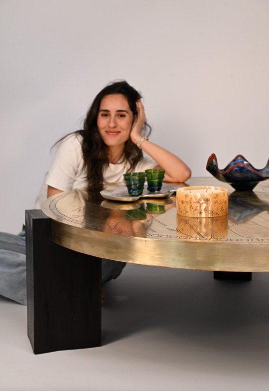 Alia Zaghloul seated at the Sun’s Grace coffee table